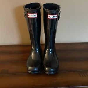 Tall glossy black hunter rain boots